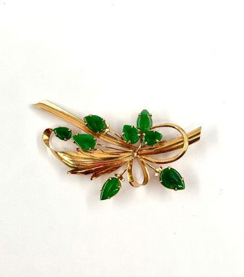 gold tone brooch with green leaves and leaves on it