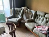 two chairs and a couch in a room with a window