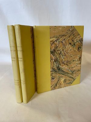 two books sitting on top of each other on a white surface