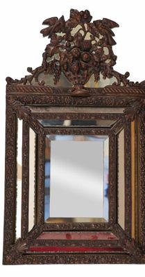 a mirror hanging on the wall with a bird on it