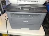 a printer sitting on top of a printer on a table