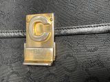 a close up of a black bag with a gold logo on it
