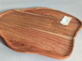 an apple shaped wooden tray with a tag on it
