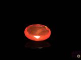 a close up of a red diamond on a black surface