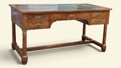 a wooden desk with a glass top on a white background