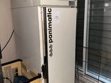 a refrigerator that is sitting in the corner of a room