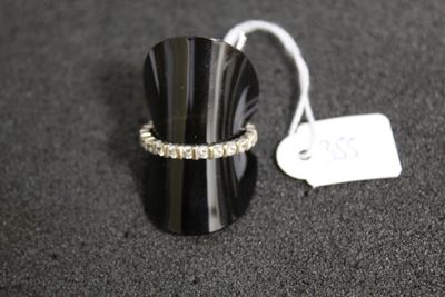 a ring that is sitting on a table next to a price tag