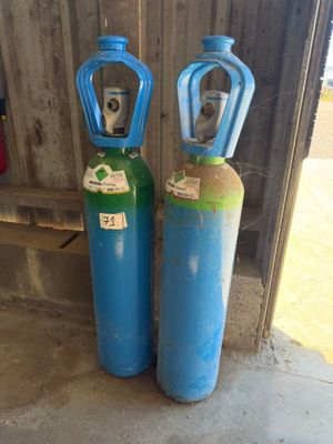 deux bouteilles de gaz bleues et vertes placées l'une à côté de l'autre