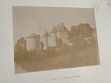 an old photo of a castle in the middle of a field