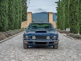 a car that is parked on a cobblestone road