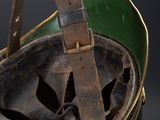 a close up of a helmet with a leather strap hanging from it ' s side