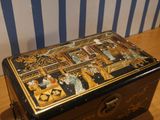 a black and gold box sitting on a wooden table
