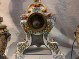 three different types of vases and a clock on the table