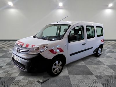 a small white van parked in a room with checkered flooring