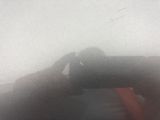 a person taking a picture with a camera on a foggy day