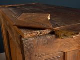 a piece of wood on top of a wooden cabinet