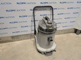 the vacuum is sitting on the floor in front of the wall