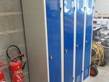 three blue lockers next to a fire extinguisor
