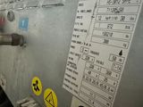 a machine that is sitting in a building with a lot of signs on it