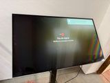 a flat screen tv sitting on a stand in a room