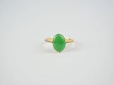 a green jade ring on a white background