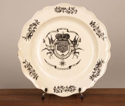 a plate with a coat of arms on it sitting on a table