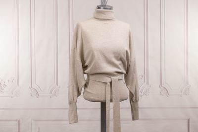 une robe posée sur un mannequin devant un mur