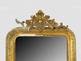 a mirror with a gold frame and a bird on it