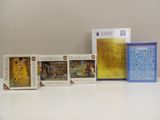 four puzzles on a table with a calculator and a puzzle box