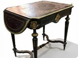 a small table with a black top and gold trim