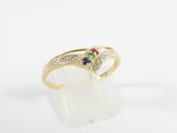 an image of a gold ring with a multicolored sapphire and diamonds