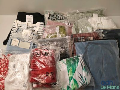 a pile of clothes and other items that are on a table