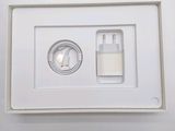 a white box with a charger and a cell phone in it