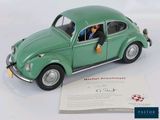 a green toy car with a dog in the passenger seat