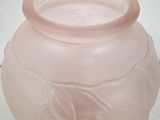 a pink glass vase with a leaf design on it