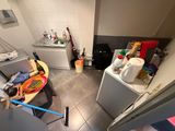 a small kitchen with a lot of clutter on the floor
