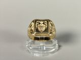 a close up of a gold ring with a shield on it