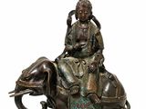 une image représentant une statue en bronze d'une femme assise sur un éléphant