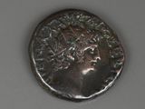 a close up of a coin with a face on it
