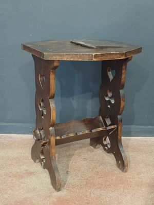 a small wooden table with a book on top of it