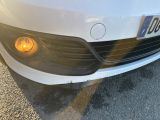 a close up of a white car with yellow lights