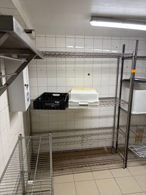 a metal shelf in the middle of a kitchen