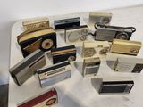 a lot of old radio ' s sitting on a table