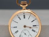 a gold pocket watch with roman numerals on it