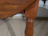 a wooden table with a wooden top on a tiled floor