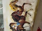 un tableau représentant un homme à cheval, posé sur un chevalet