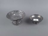 a pair of silverplated bowls and a bowl on a grey background