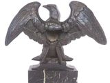a statue of an eagle on a marble base