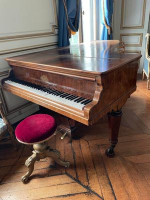 a grand piano in the corner of a room