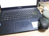 a laptop computer sitting on a desk with a mouse and a mouse pad